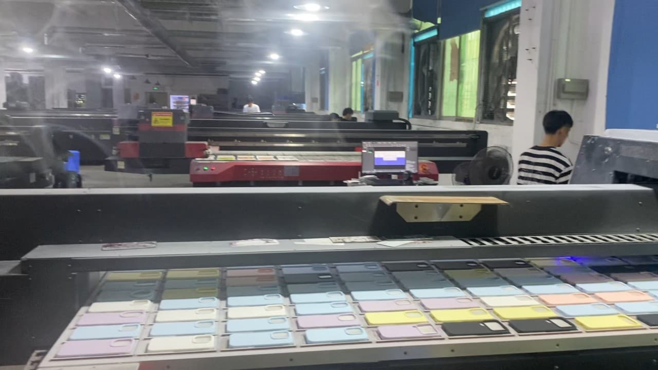 Phone cases moving through a UV print production line