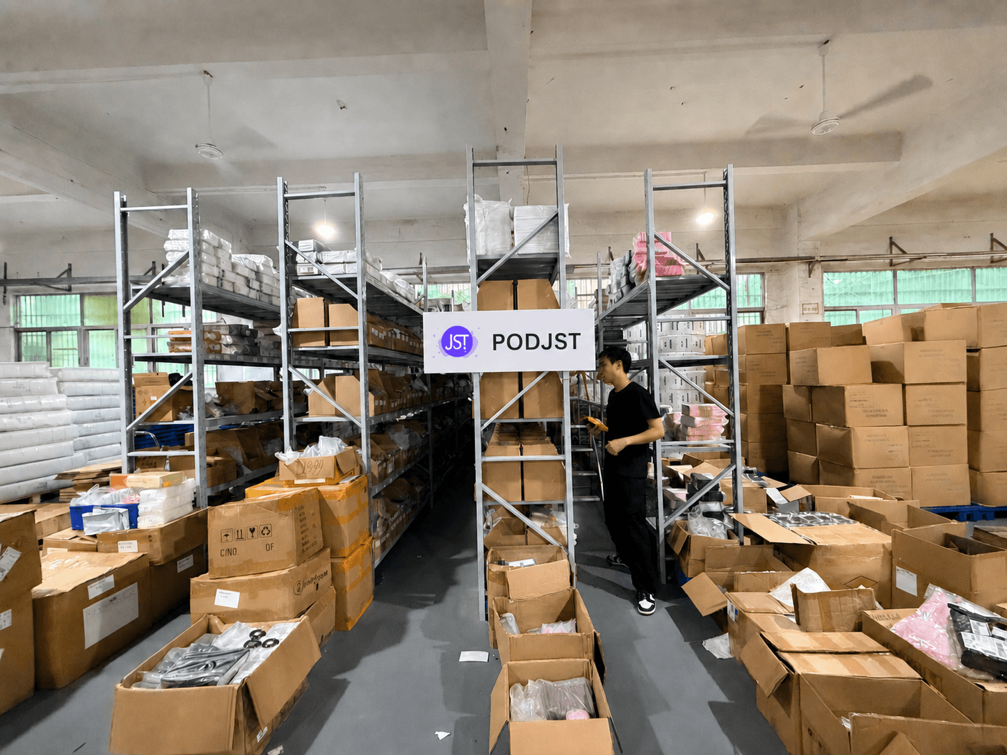 PODJST warehouse shelves stocked with products and packing inventory